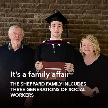 Three people - an older man with white hair and dark top on the left, a young man with a graduation cap and gown holding a parchment in the middle, and a middle-aged woman with shoulder length blond hair and a dark top on the right.